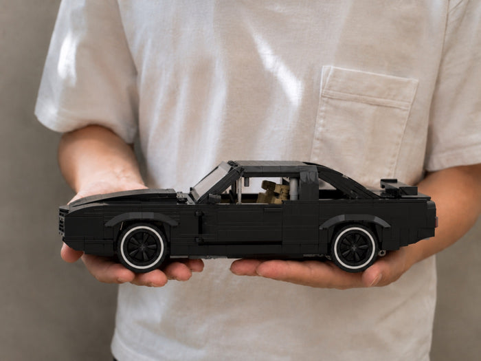 The finished K.I.T.T model resting across two open hands, for scale