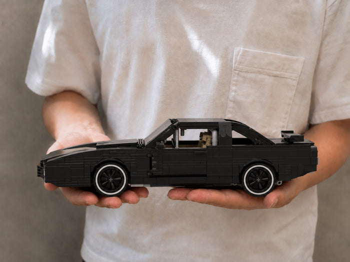 The finished K.I.T.T model resting across two open hands, for scale